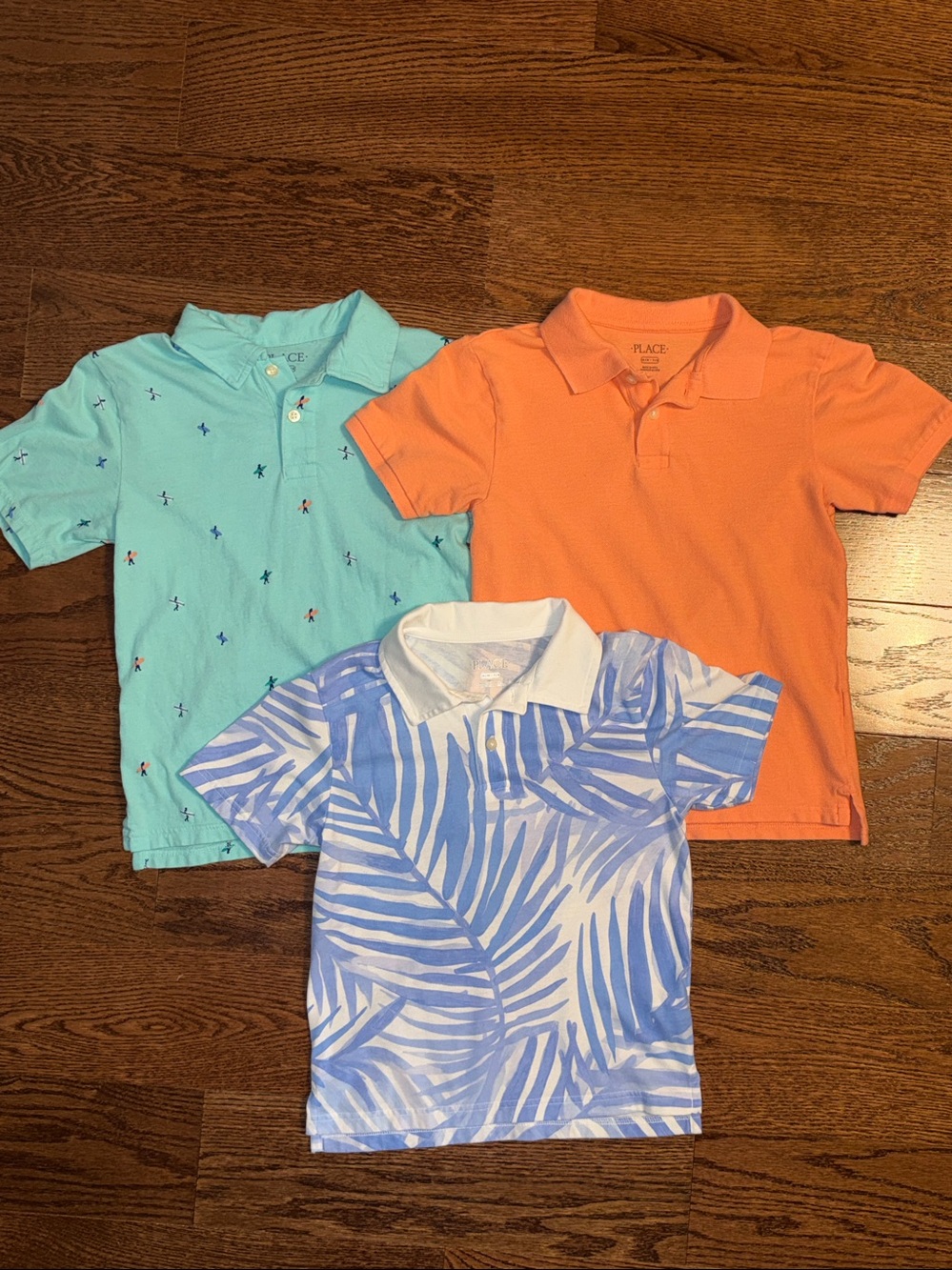 Size M/7-8 boys bundle of 3 polo shirts. Solid and tropical print.